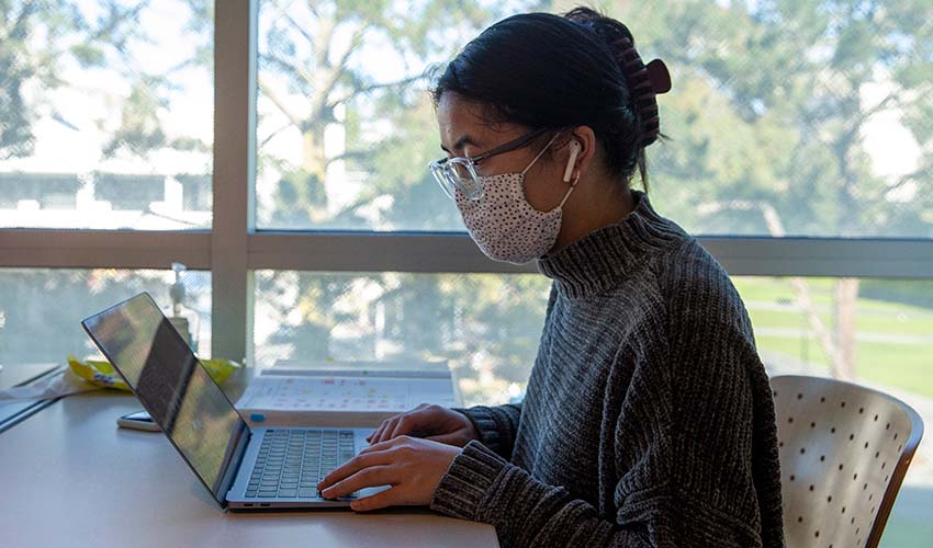 Student wearing mask on computer