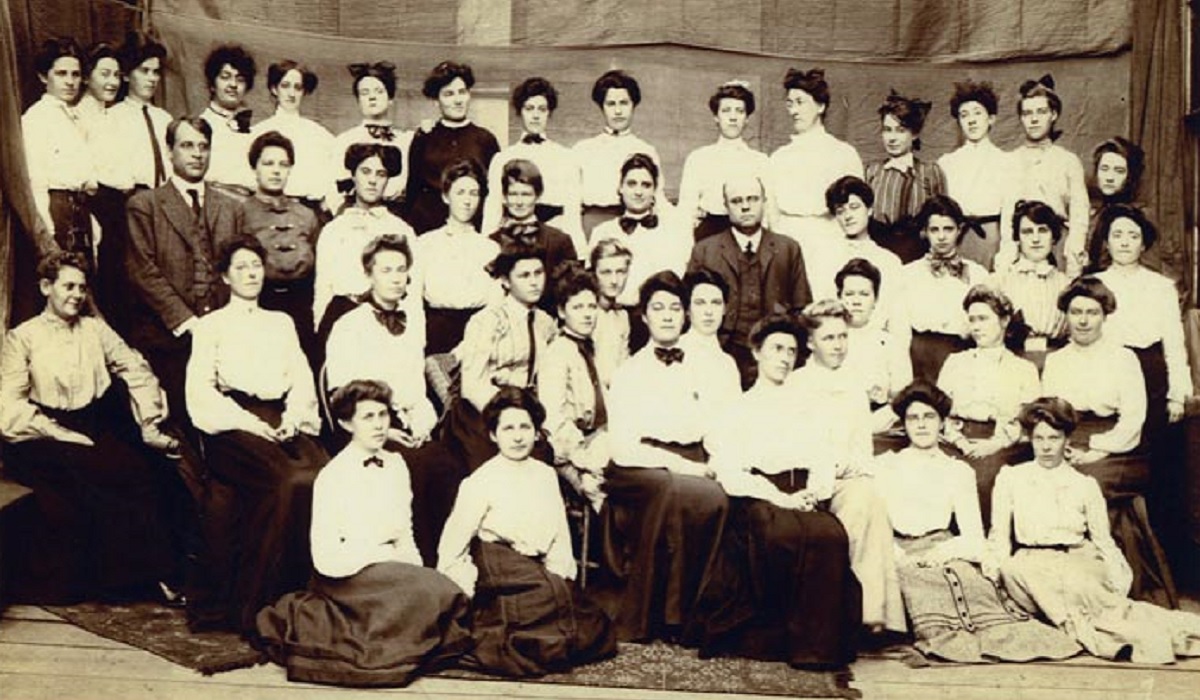 A group of female students and two male instructors circa 1906