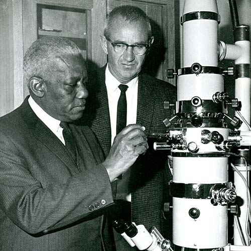 Robert Thornton and John Hensill using lab equipment