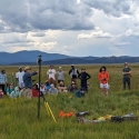 Students and faculty out in a field on a cloudy day