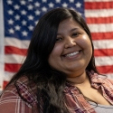 Briana Torres in front of an American flag