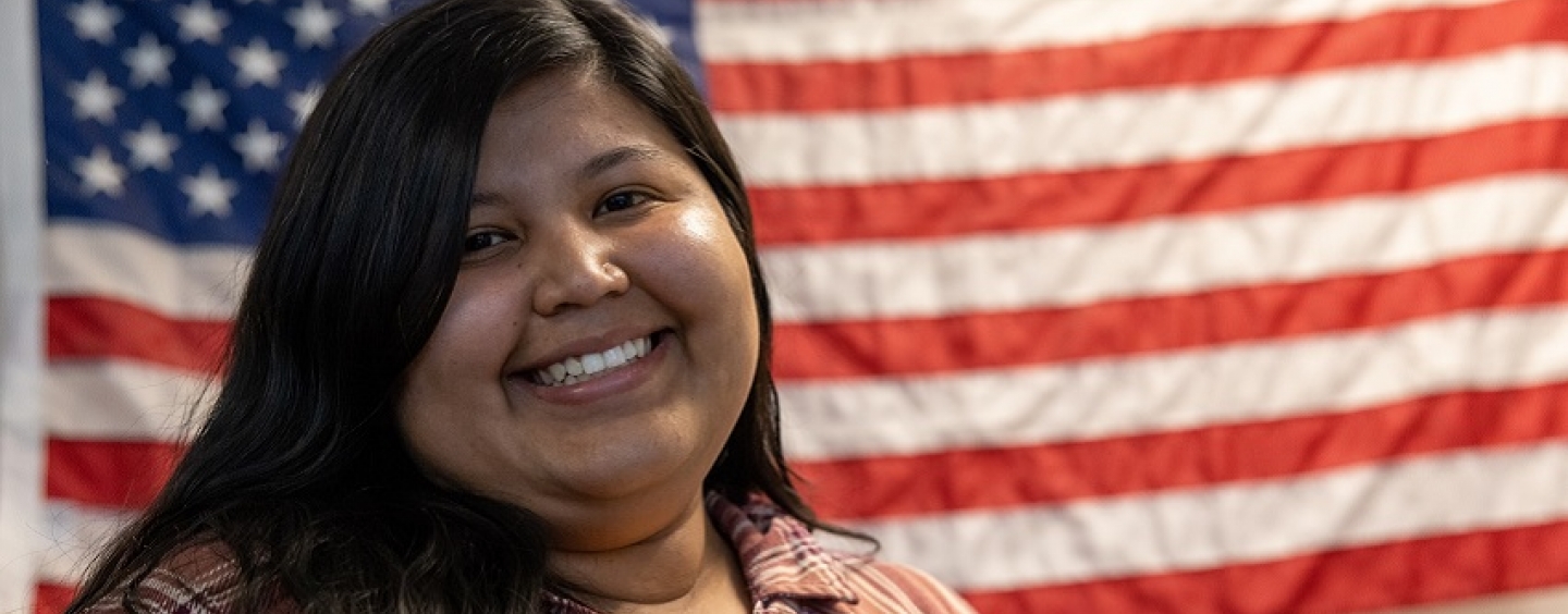 Briana Torres in front of an American flag