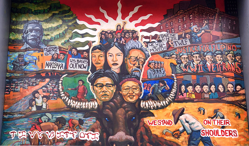 A colorful mural with a brown buffalo, and depictions of the faces of Asian American historical figures. Images of the 1968 Third World Liberation Front strikers are also present.