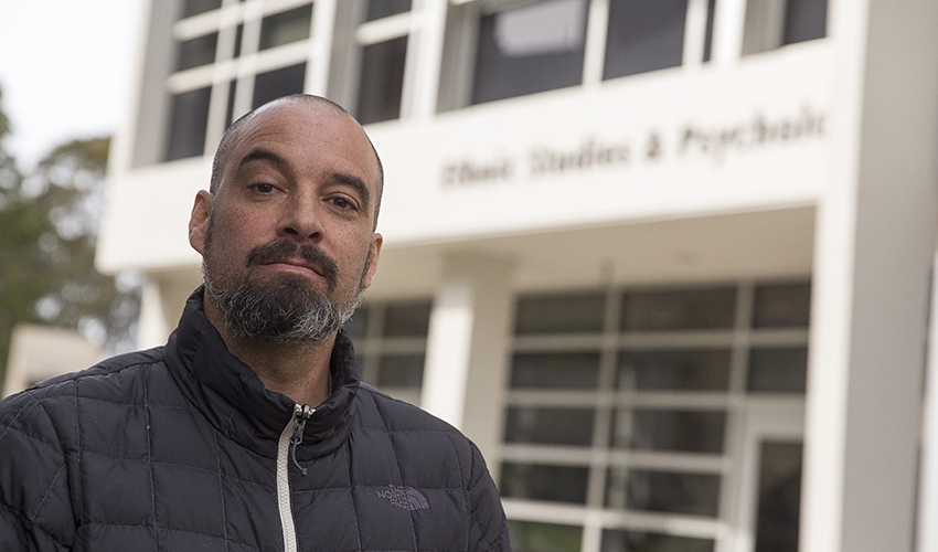 SF State Associate Professor Jeff Duncan-Andrade stands in front of the ethnic studies building.