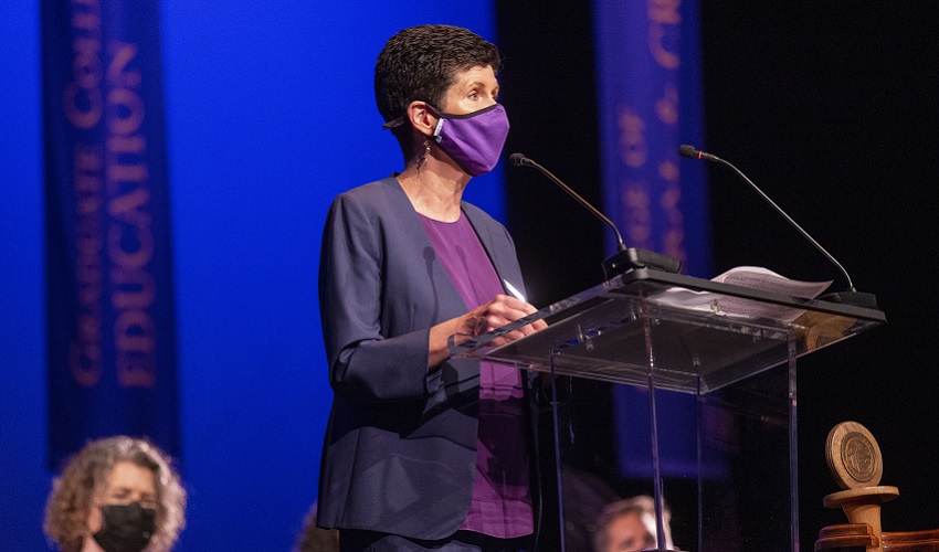 President Mahoney at a podium wearing a mask