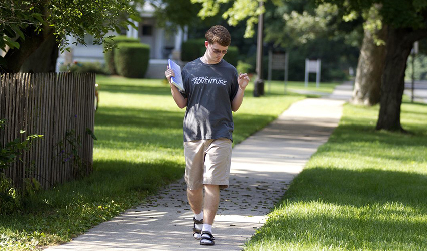 Photo of Deej walking on a street