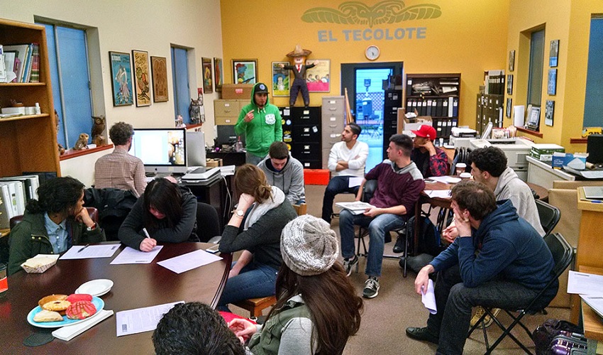 Students meet with an editor in the El Tecolote office