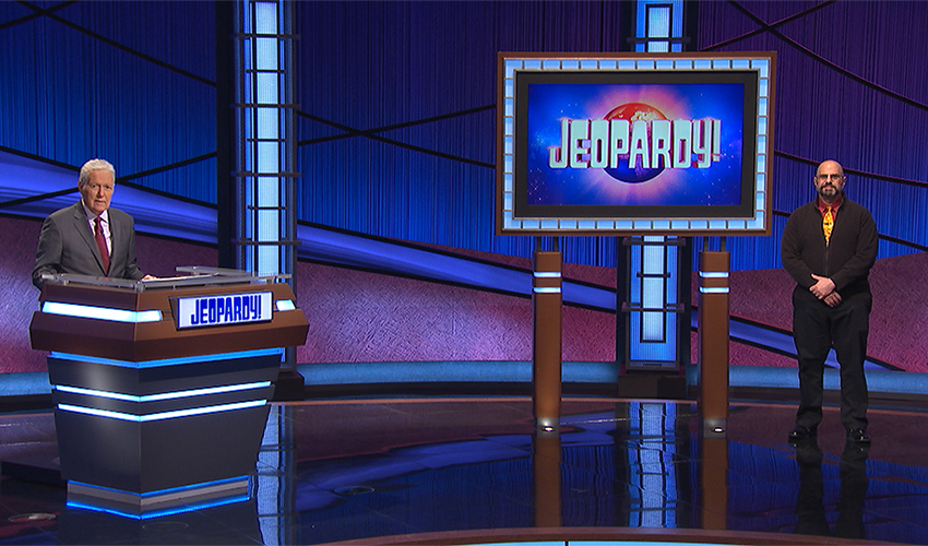 Assistant Professor James Gilligan on the "Jeopardy!" set with late host Alex Trebek.