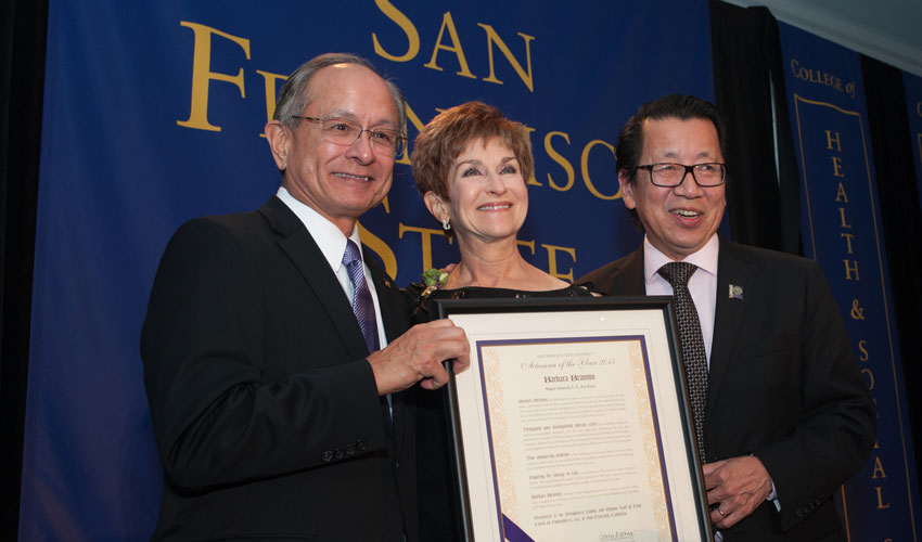 President Les Wong and alum Ben Fong-Torres presenting Barbara Lavis Brannon with her 2015 Alumna of the Year award.