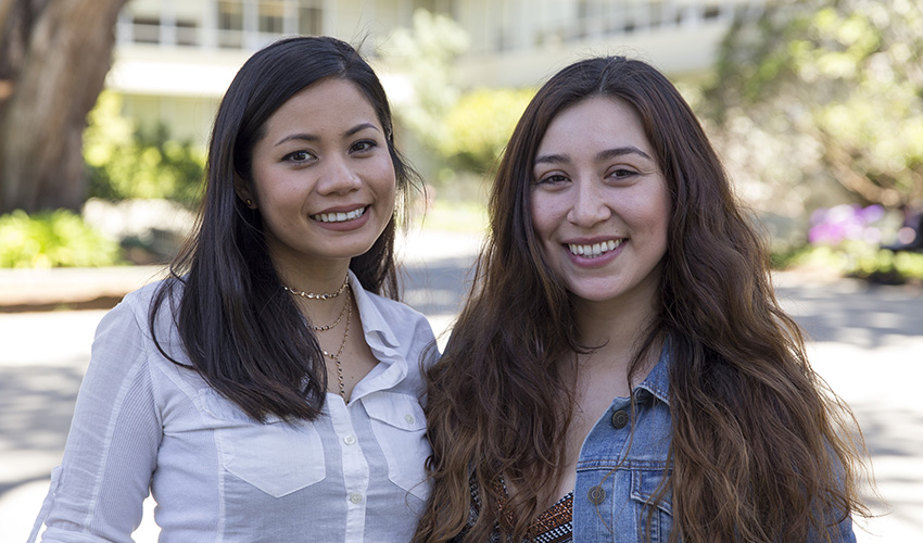 Francesca Zulueta and Rubi Esmeralda Gutierrez are standing next to each other outside smiling.