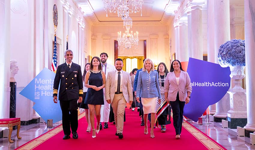 A group including Juan Acosta, First Lady Jill Biden and Selena Gomez walking through White House