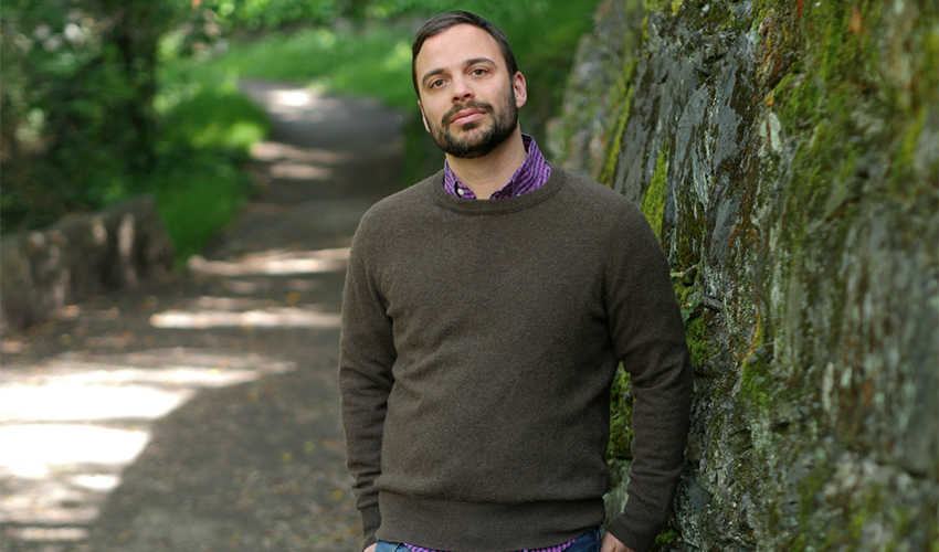 Assistant Professor of Creative Writing Michael David Lukas standing by a tree.
