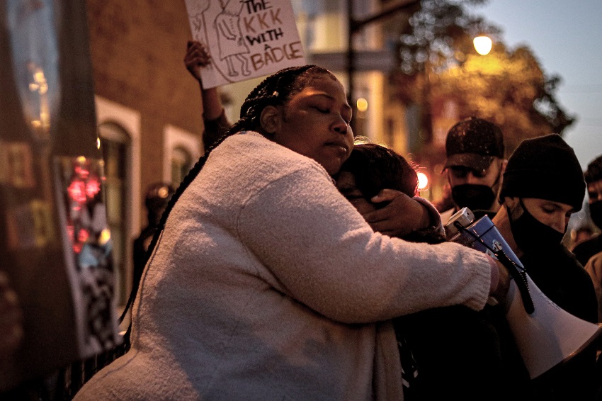 Talika Fletcher consoles a fellow protester during a vigil and march held in honor of Roger Allen and Daunte Wright.