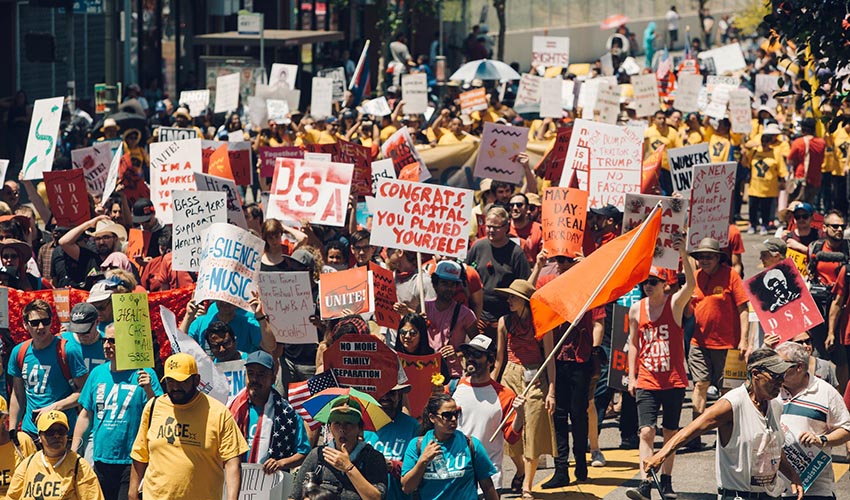Workers striking fill a street in Los Angeles.