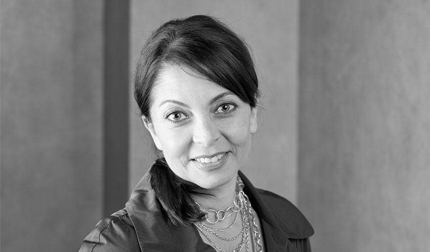 A black and white image of a smiling Neda Nobari
