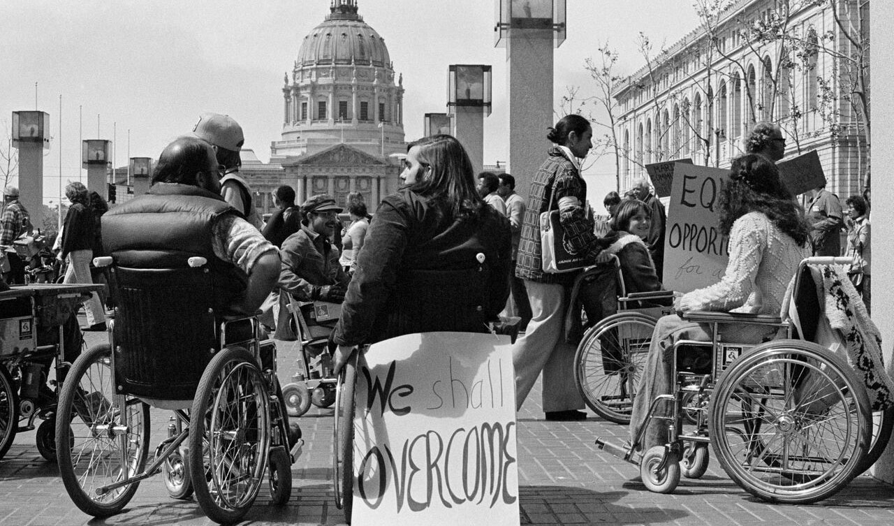 Protestors demonstrating outside San Francisco's 50 UN Plaza Building in April 1977.