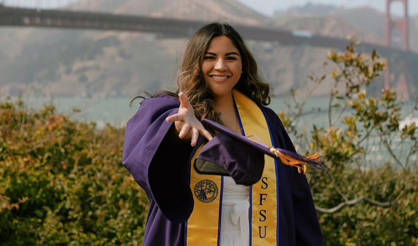 Graduating Gator Roxanna Sotelo tosses her cap near the Golden Gate Bridge