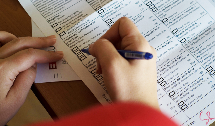A voter filling out an election ballot.