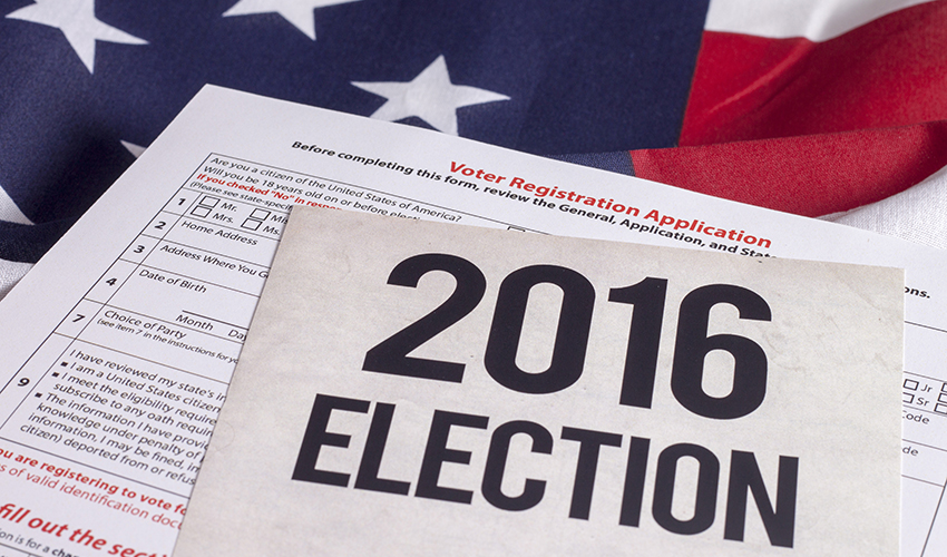 Stock photo of voter registration application and sign that says "2016 Election" on what looks like an American flag.