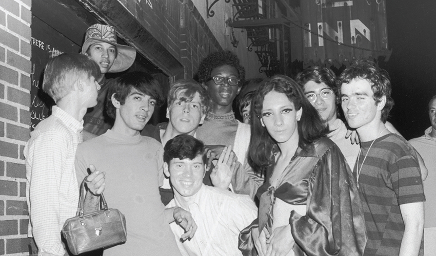 Members of the Stonewall riots posing for a picture by the actual Stonewall Inn in 1969.