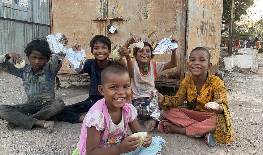 Smiling children with food packets