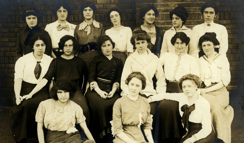 Three rows of female students depicted in a sepia-tone historical photograph