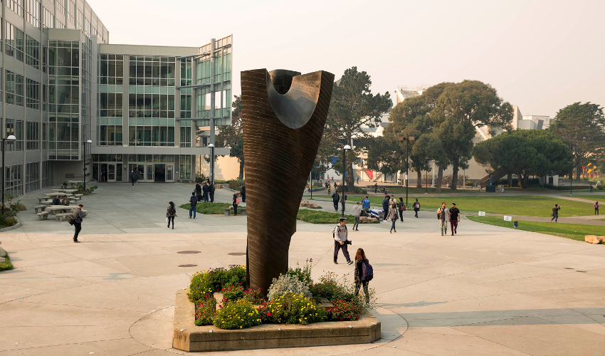 A campus sculpture with smoky haze in the background
