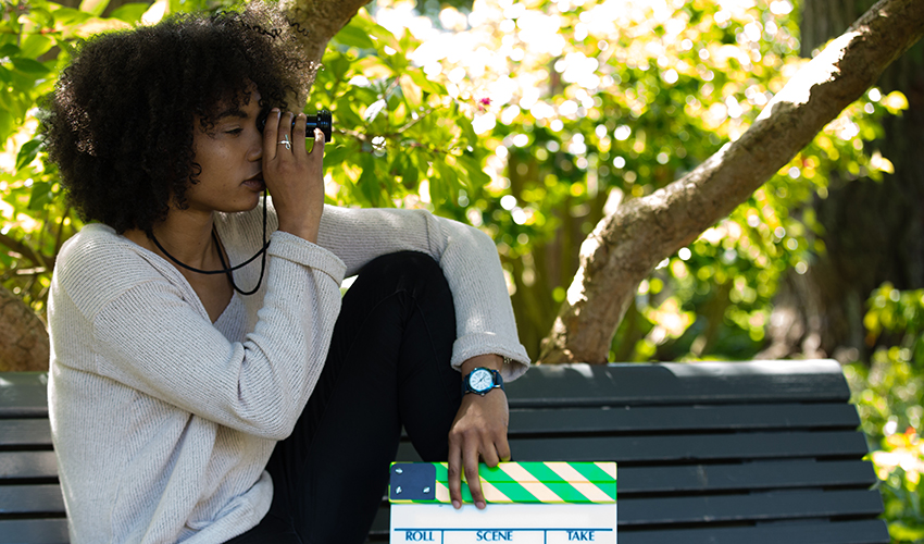 Anaiis holding a directors clapboard