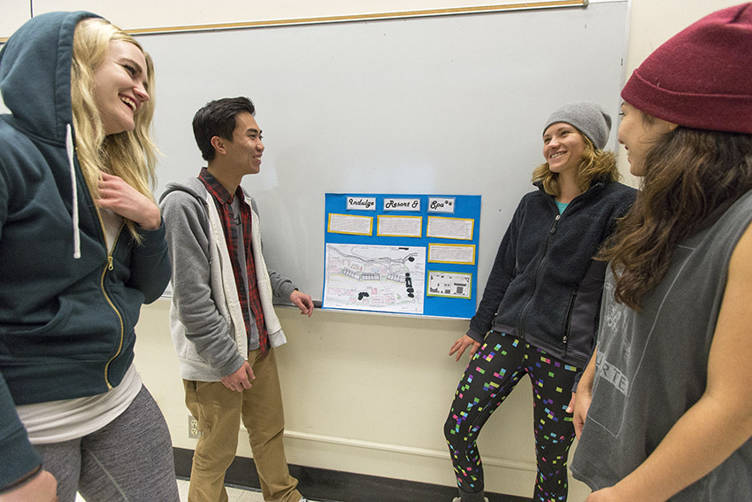 SF State students, look at a final project for the “Recreation Destination Resorts” class inside a classroom in the School of Business on Dec. 8.