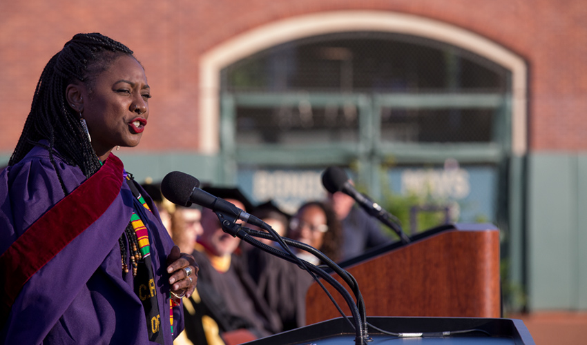 Grad student Alicia Garza addresses crowd at AT&T Park