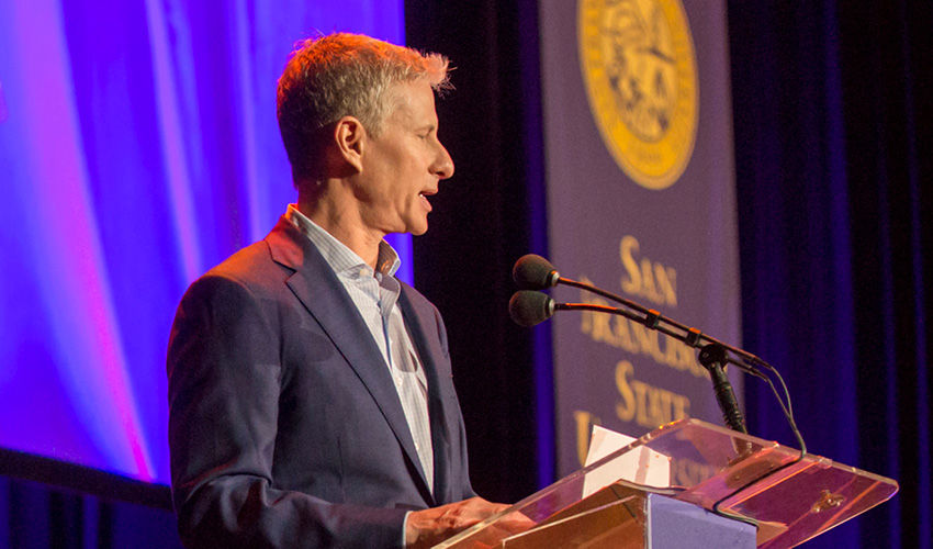 Chris Larson speaking at a podium