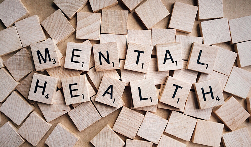 Scrabble pieces that spell the words 'Mental Health'.