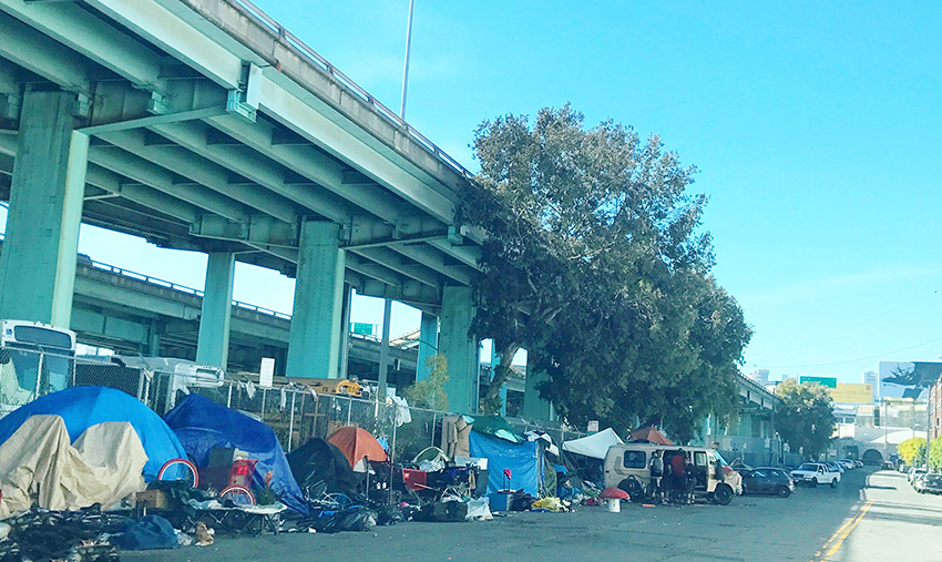Homeless encampment close to freeway.