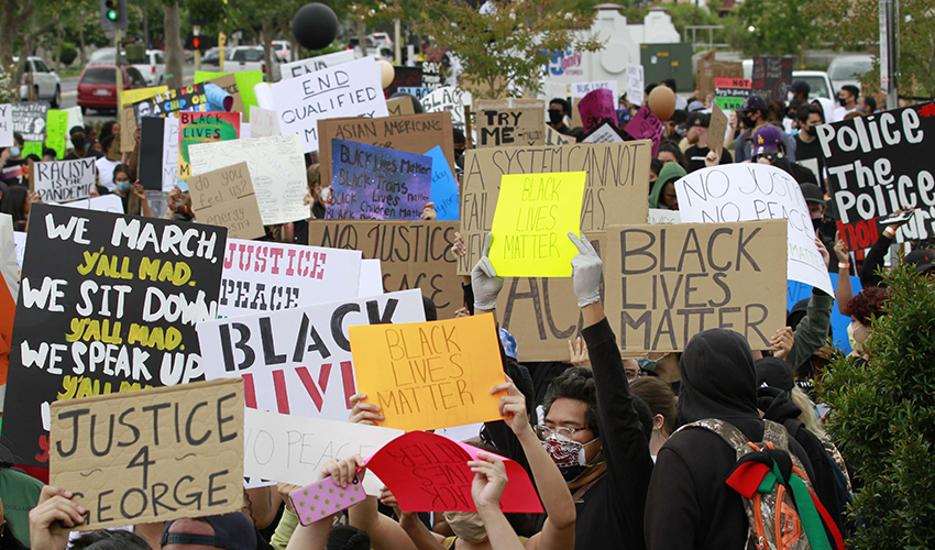 Group of protesters holding signs in support of Black Lives Matter.