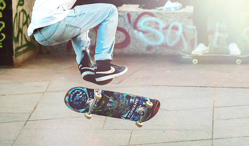 Skateboarder doing a trick in midair.