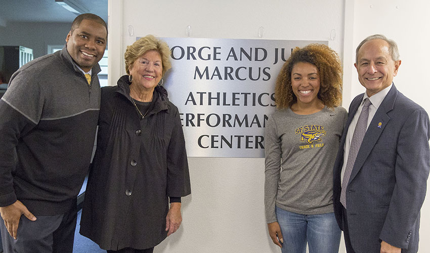 Athletic Director Charles Guthrie, alum Judy Marcus, track and field athlete Tamiyah Thomas and President Les Wong in front of a sign reading "George and Judy Marcus Athletic Performance Center."