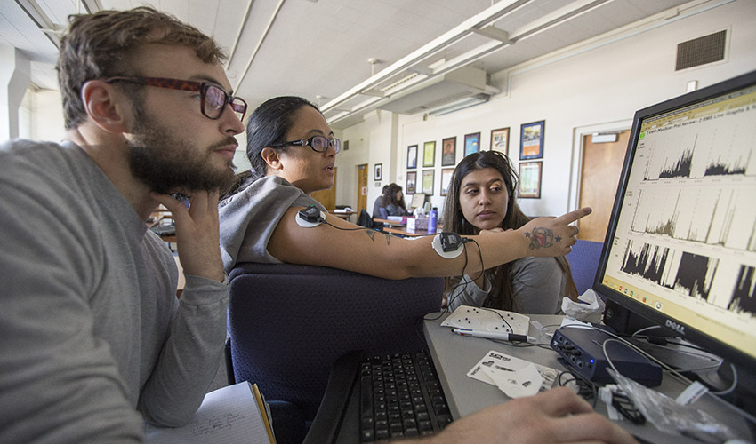 Students looking at biofeedback data on a computer screen