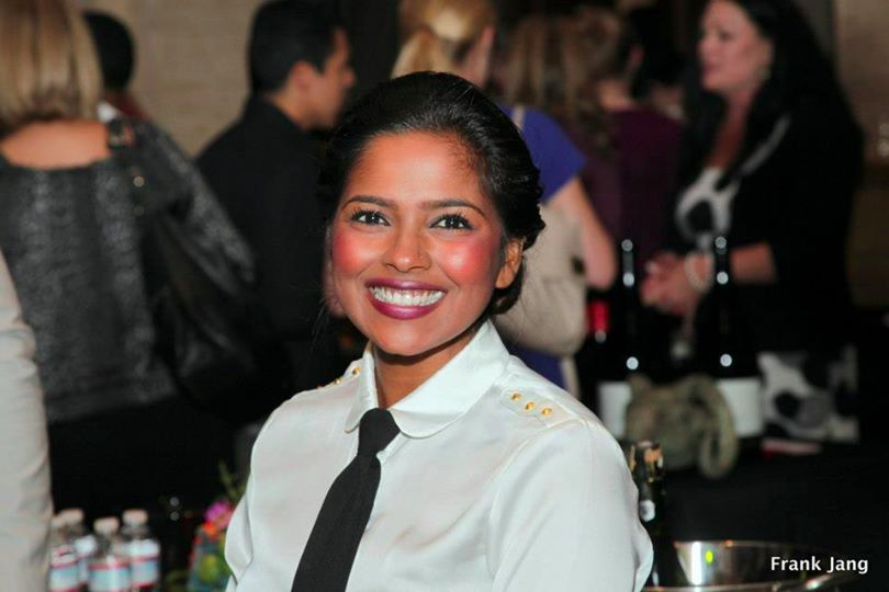 A smiling student works at Taste of the Bay 2014.