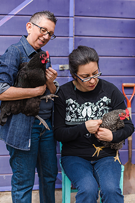 Luz and Catriona holding chickens