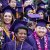 Photo of SF State student in purple caps and gowns