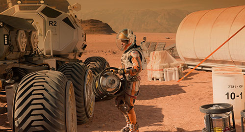 Still of "The Martian's" Mark Watney with equipment on Mars by photographer Giles Keyte courtesy of 20th Century Fox.