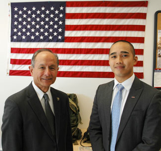 Photo of student John Sonza with University President Les Wong