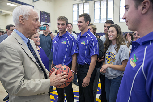 Don Nasser being presented a basketball signed by SF State student athletes.