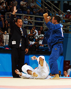 A photo of an Olympic judo athlete displaying triumphant body language following victory.