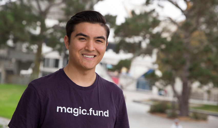 Student Matt Greenleaf, wearing a purple shirt with the text "magic.fund"
