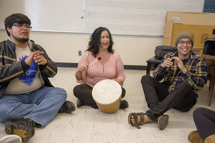 San Francisco State University Professor of Music Education Wendell Hanna sits on the floor and drums as she teaches students in her music education class.