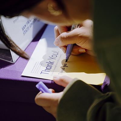 A student signs a card 