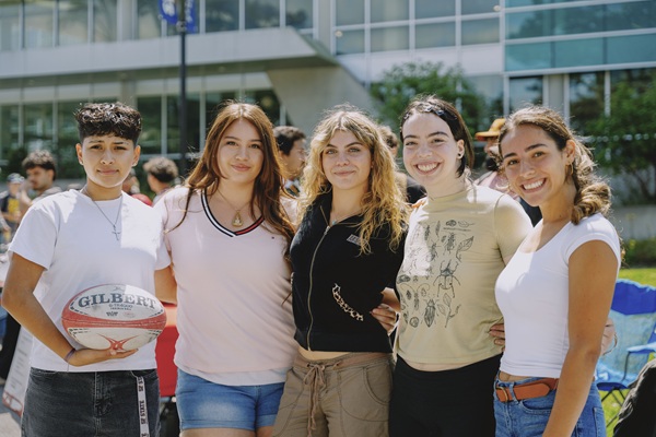Female students smile on the Quad