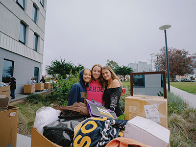 Three students smiling during move-in day