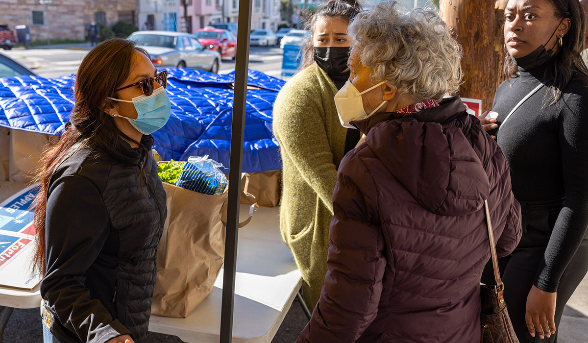 SF State student fellows in the #CaliforniansForAll College Corps help distribute Thanksgiving turkeys and other foods to senior citizens outside the IT Bookman Community Center. 